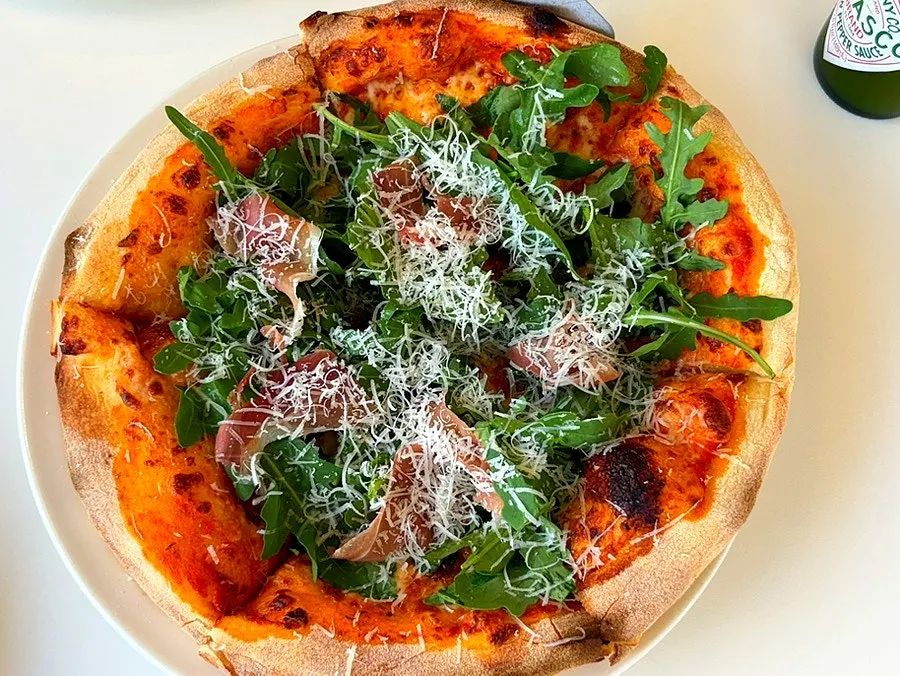 A pizza slice showing the chewy dough