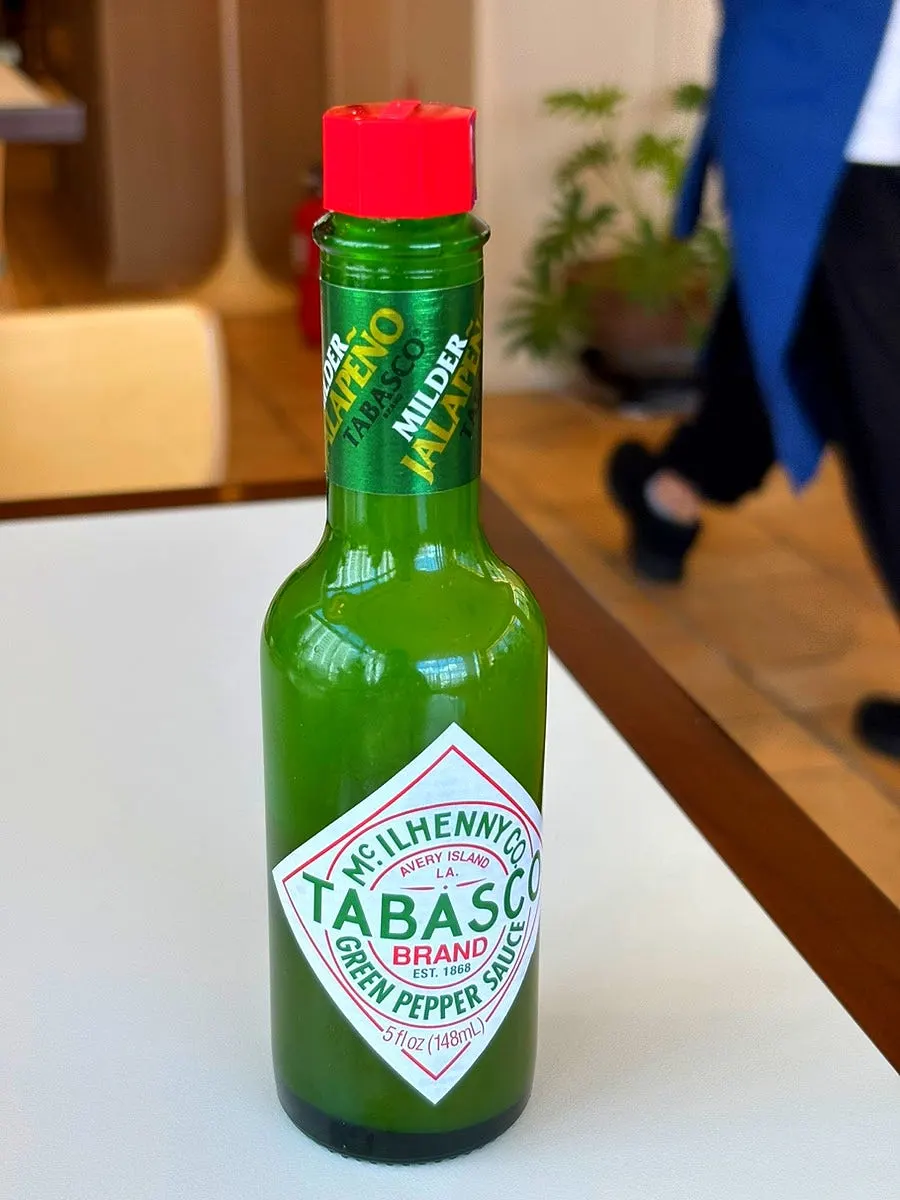 Green hot sauce served with the pizza