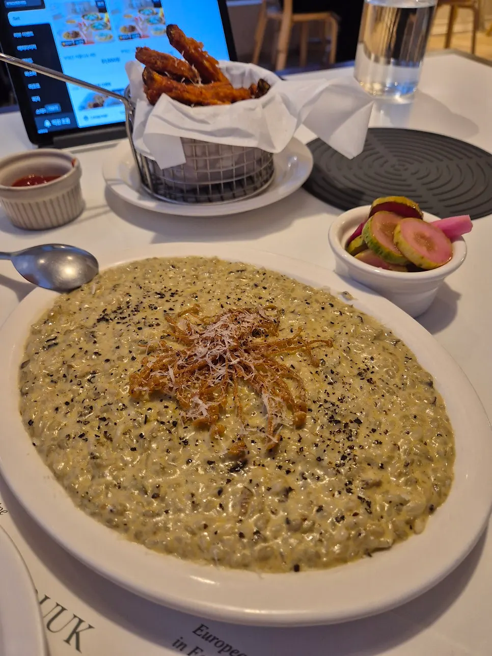 Abalone cream risotto topped with fried enoki mushroom