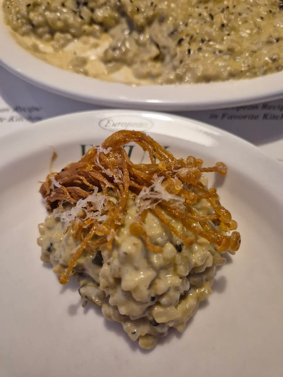 A spoonful of risotto showing abalone and clam meat