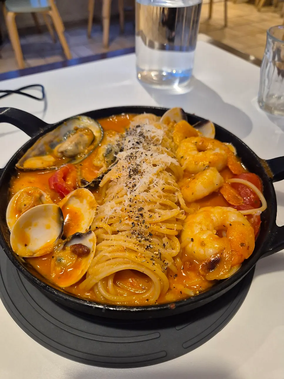 Seafood tomato pasta served in a clay pot