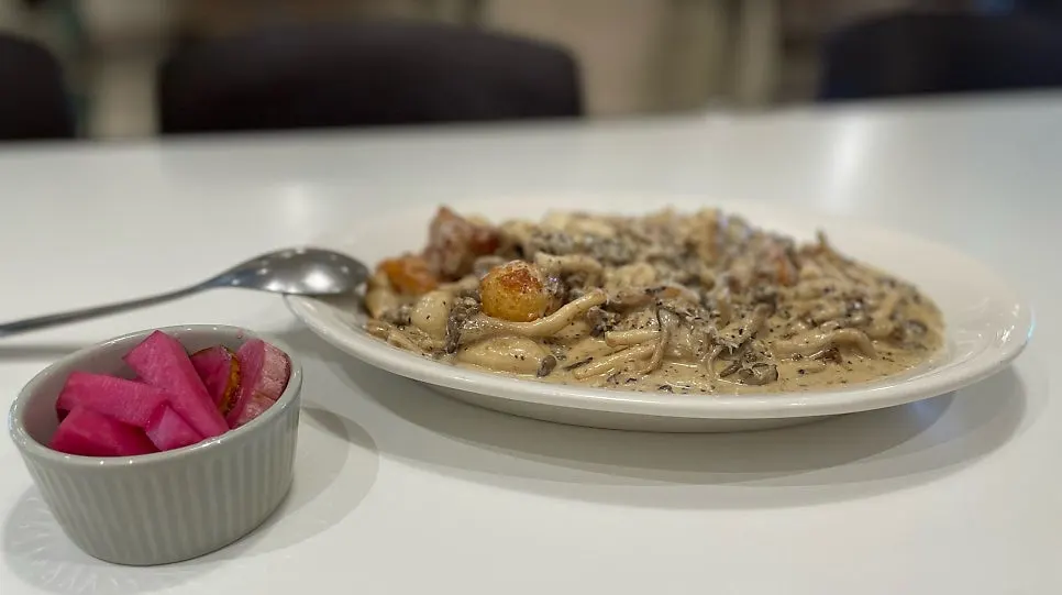Table spread with pizza and gnocchi together at Bueokgan Haeundae Branch