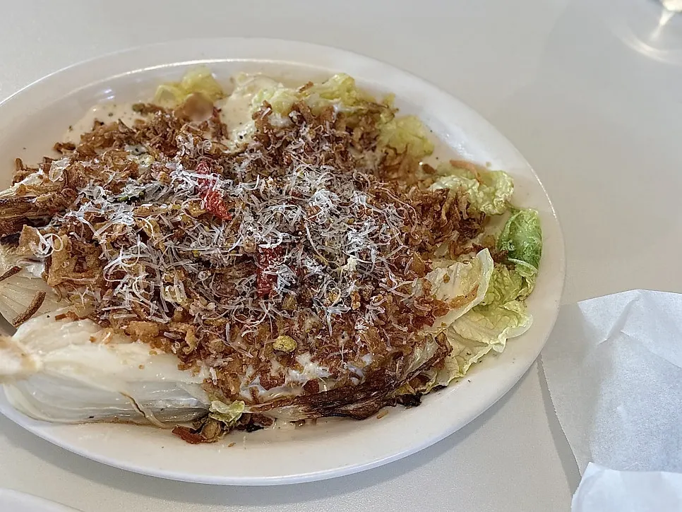 Napa cabbage Caesar salad loaded with bacon chips and cheese