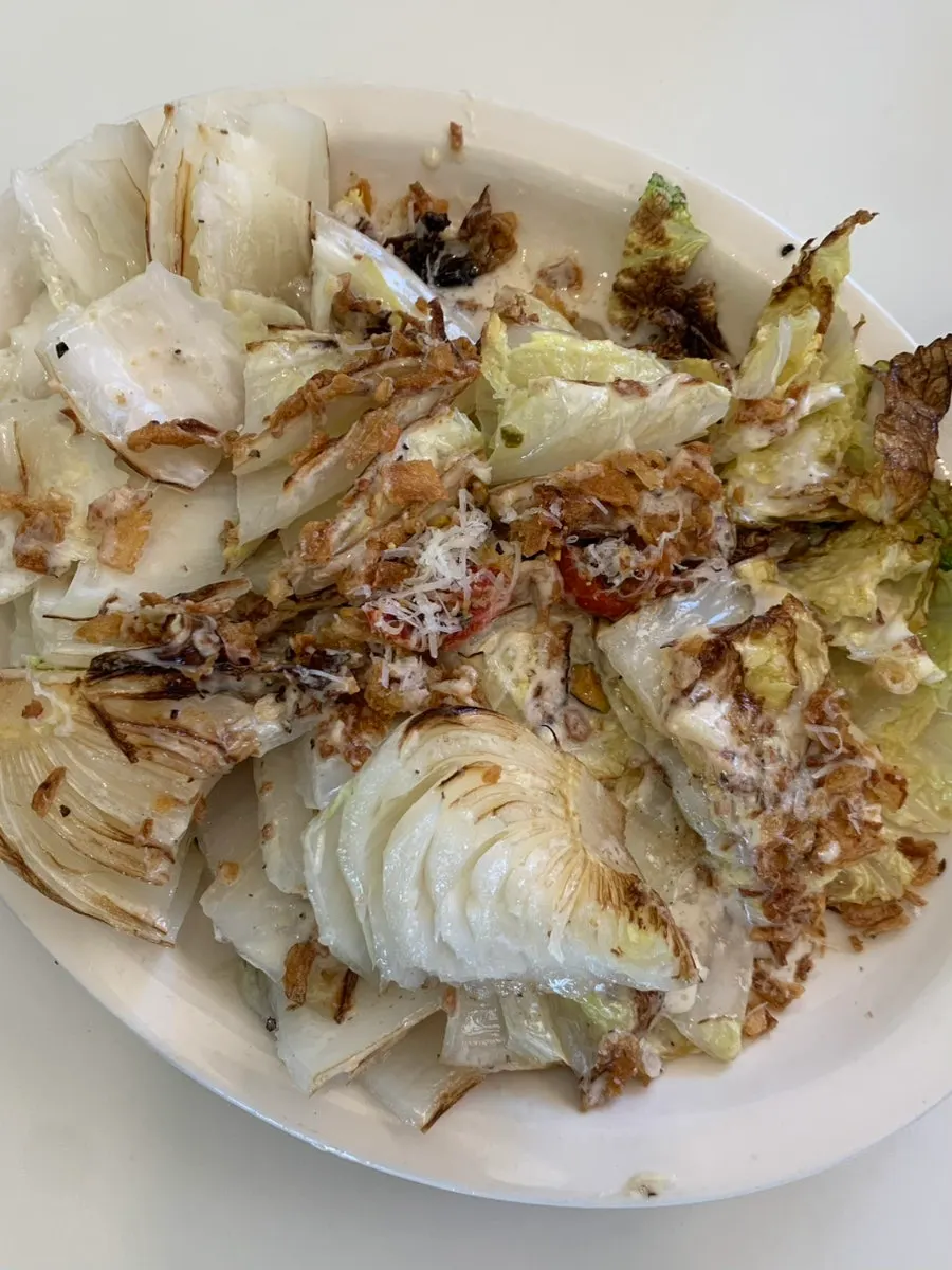 Caesar dressing over charred napa cabbage