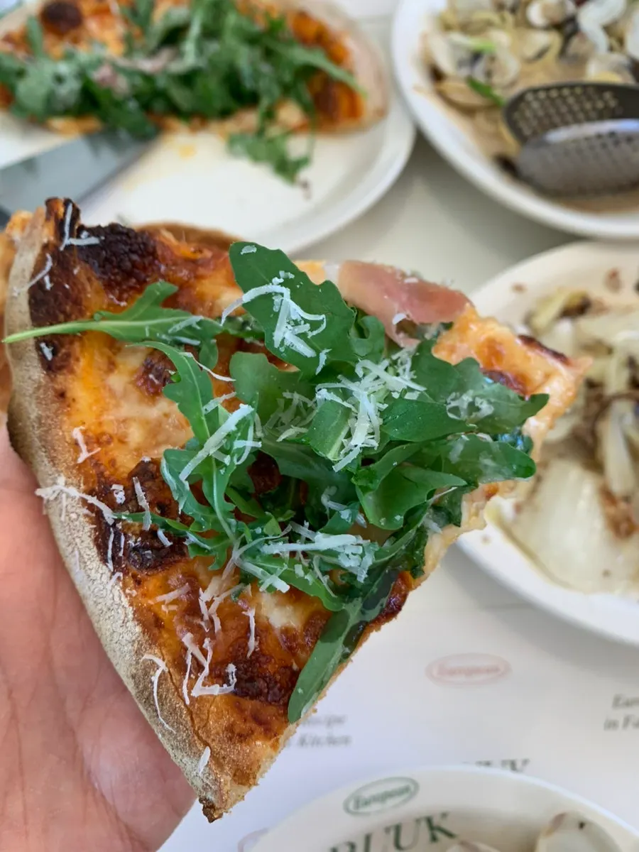 A whole arugula prosciutto wood-fired pizza