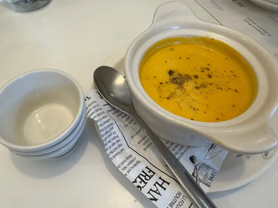 A bowl of golden pumpkin soup