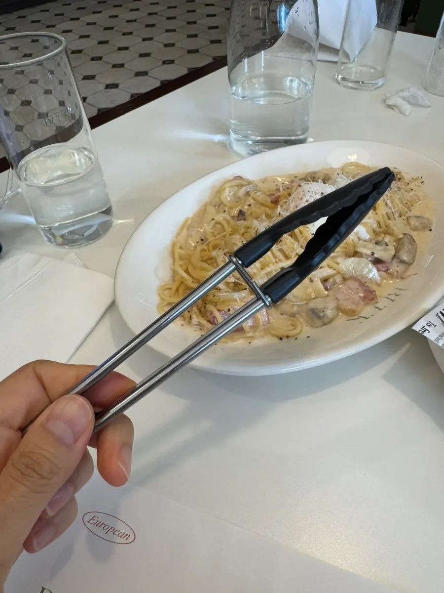 Carbonara noodles twirled around a fork