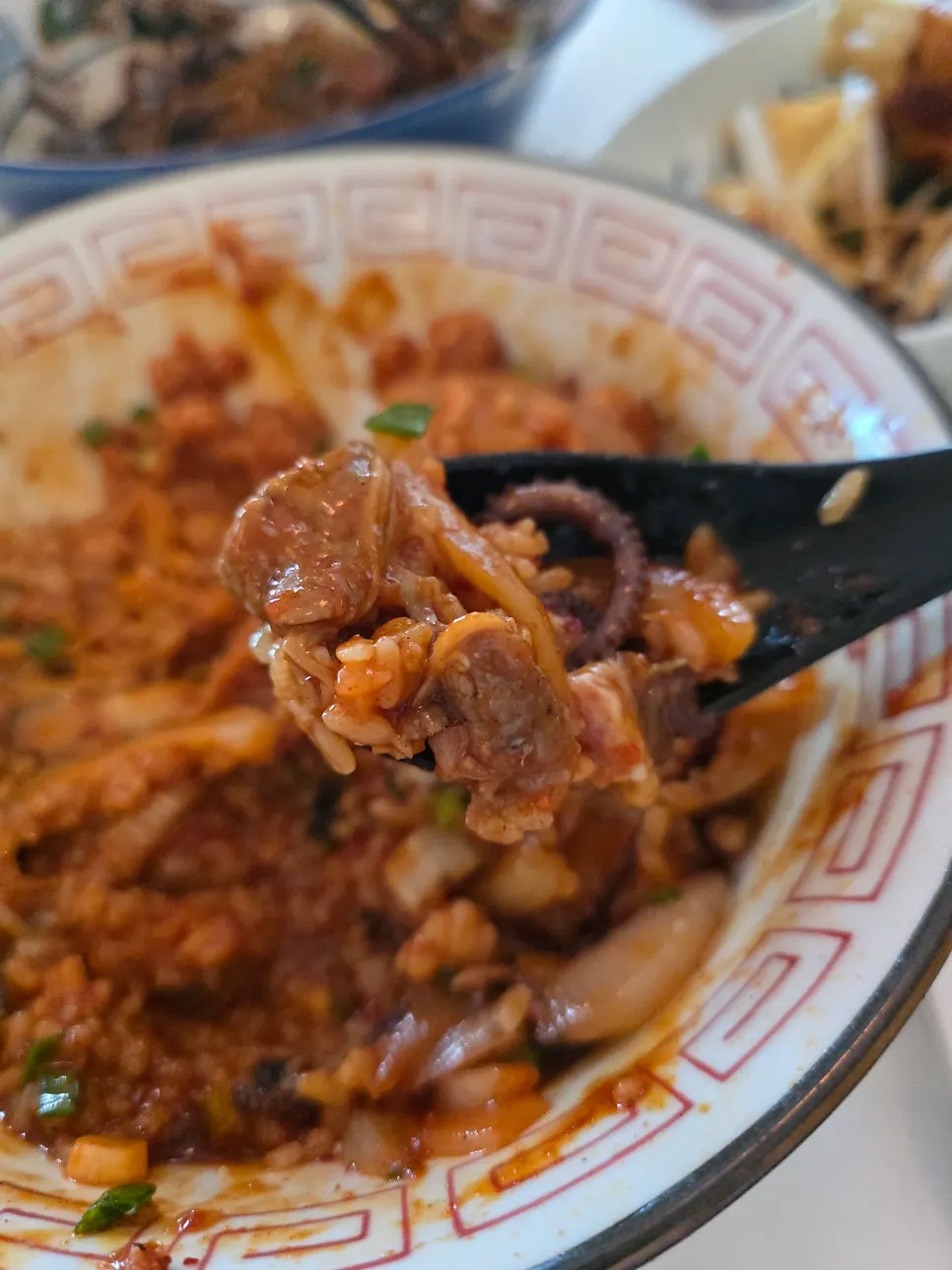 Close-up of the octopus jungwha rice bowl with generous sauce