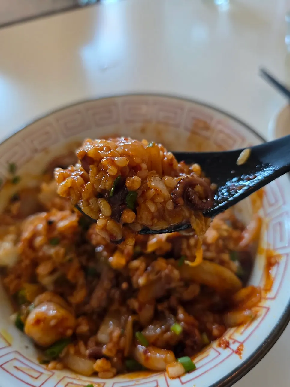 A spoonful of the rice bowl showing the plump octopus