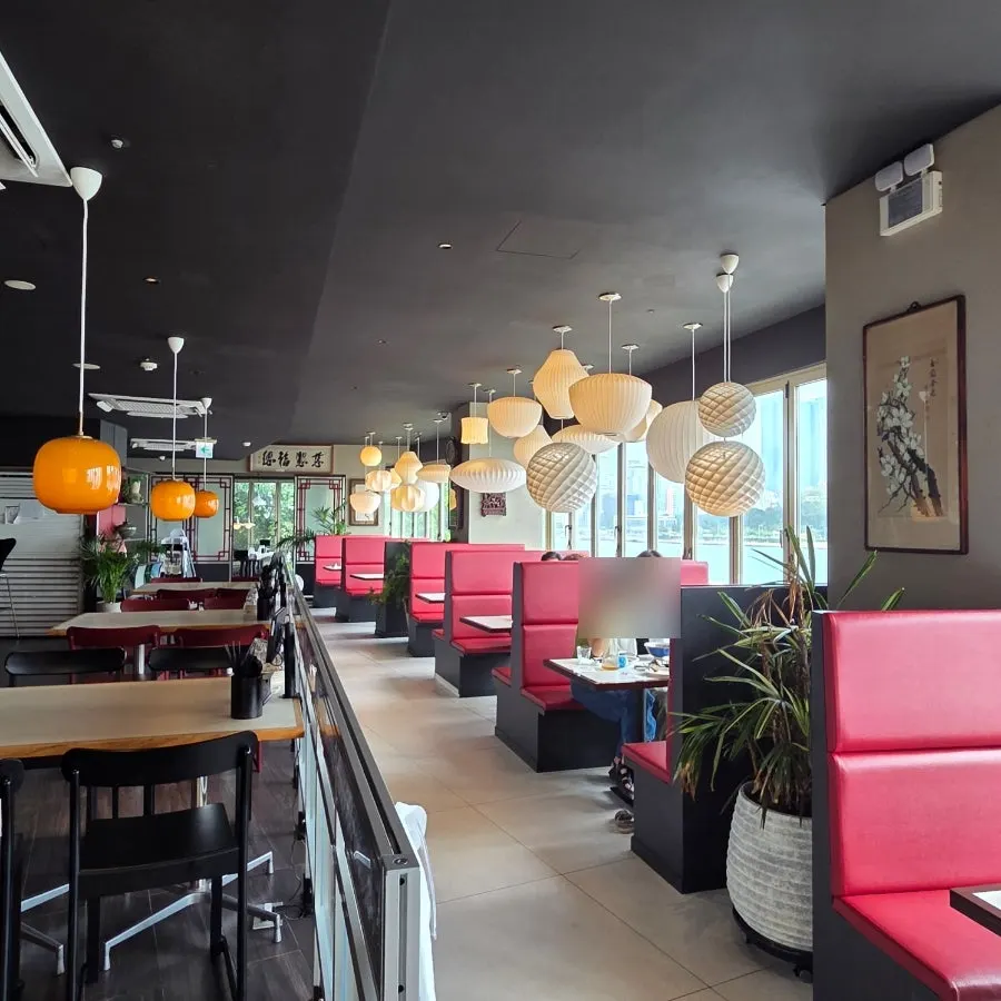 Ocean-view tables arranged along the windows of the curved building