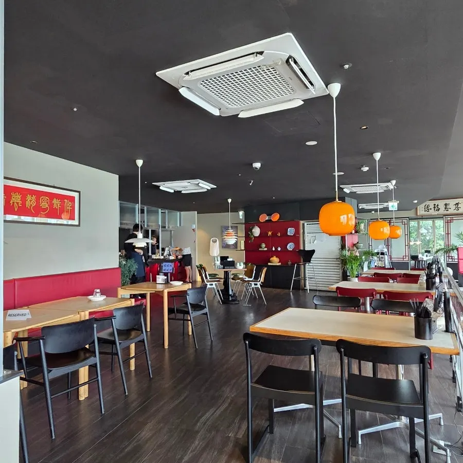 Bright Chinese restaurant hall with red accent details