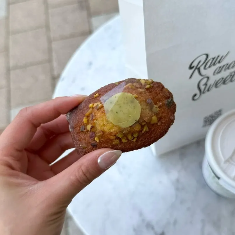 Pistachio madeleine with a bite taken out