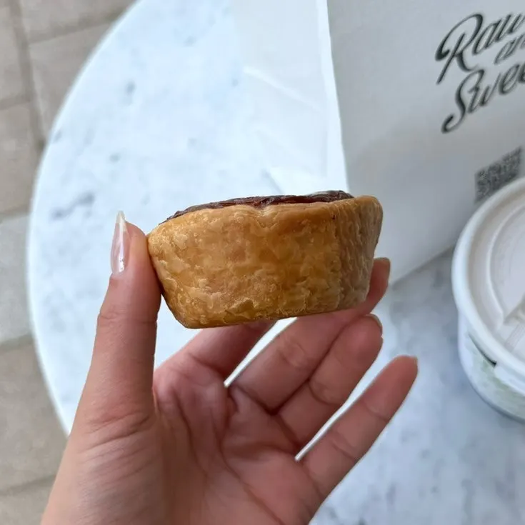 Egg tart showing crisp pastry layers