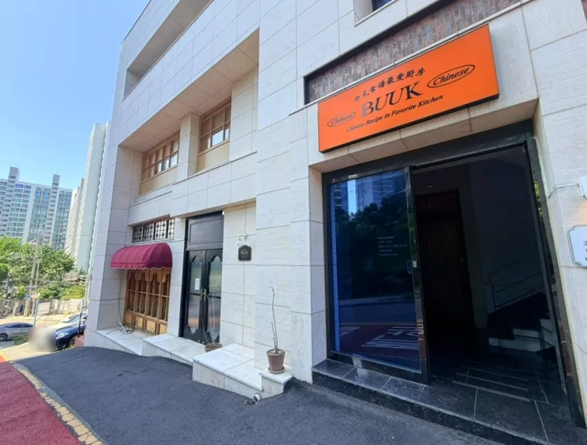 Exterior of the building housing Bueokgan Haeundae Branch and its parking area