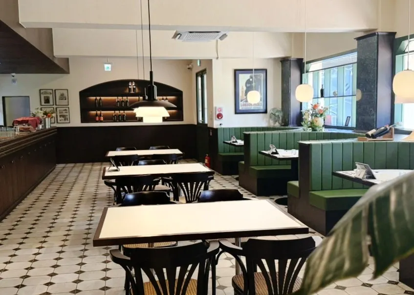 Right-side dining room at Bueokgan with green-accent lighting