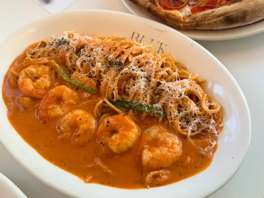 Shrimp rosé pasta topped with shrimp and mushrooms