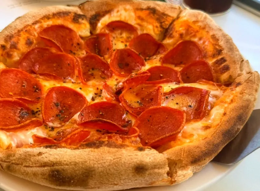 Pepperoni pizza loaded with toppings at Bueokgan