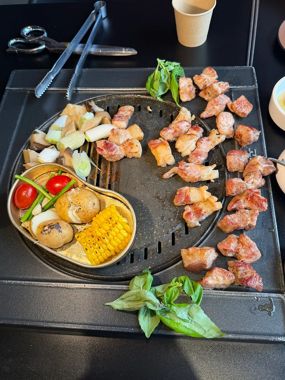 Pork neck topped with chimichurri sauce and basil wrap