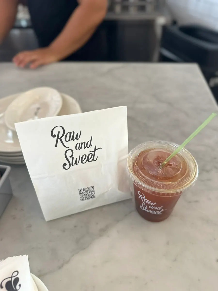 Iced americano and bread bag packed to go