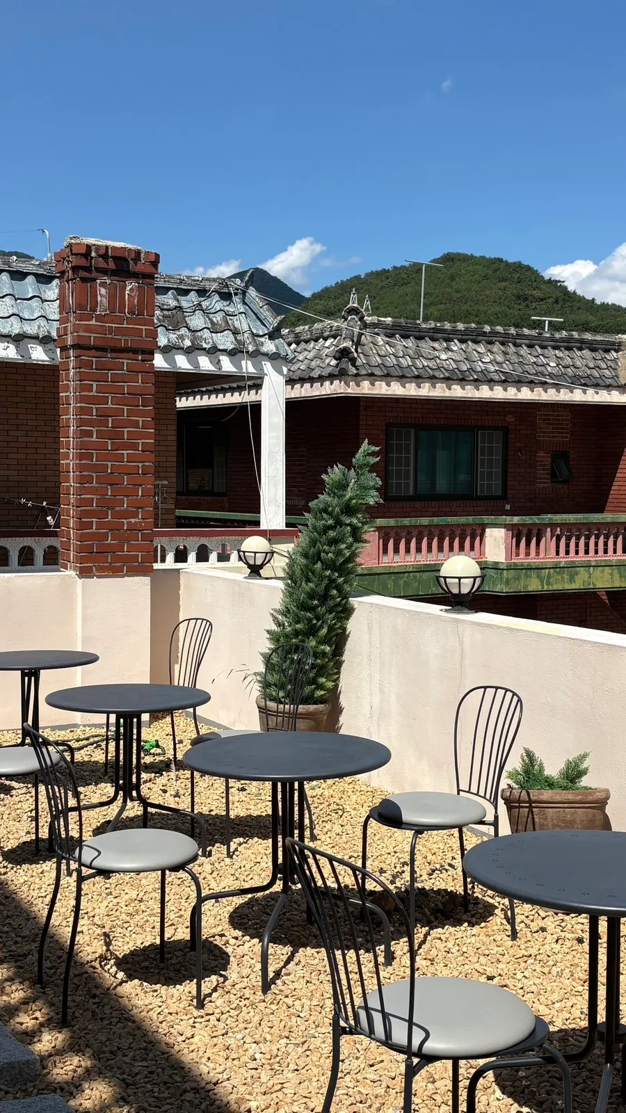 Outdoor terrace tables and chairs at Geumsong Deokmi