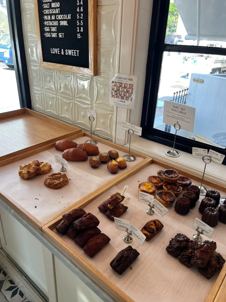 Dessert display with canelé, financiers, croissants, and more