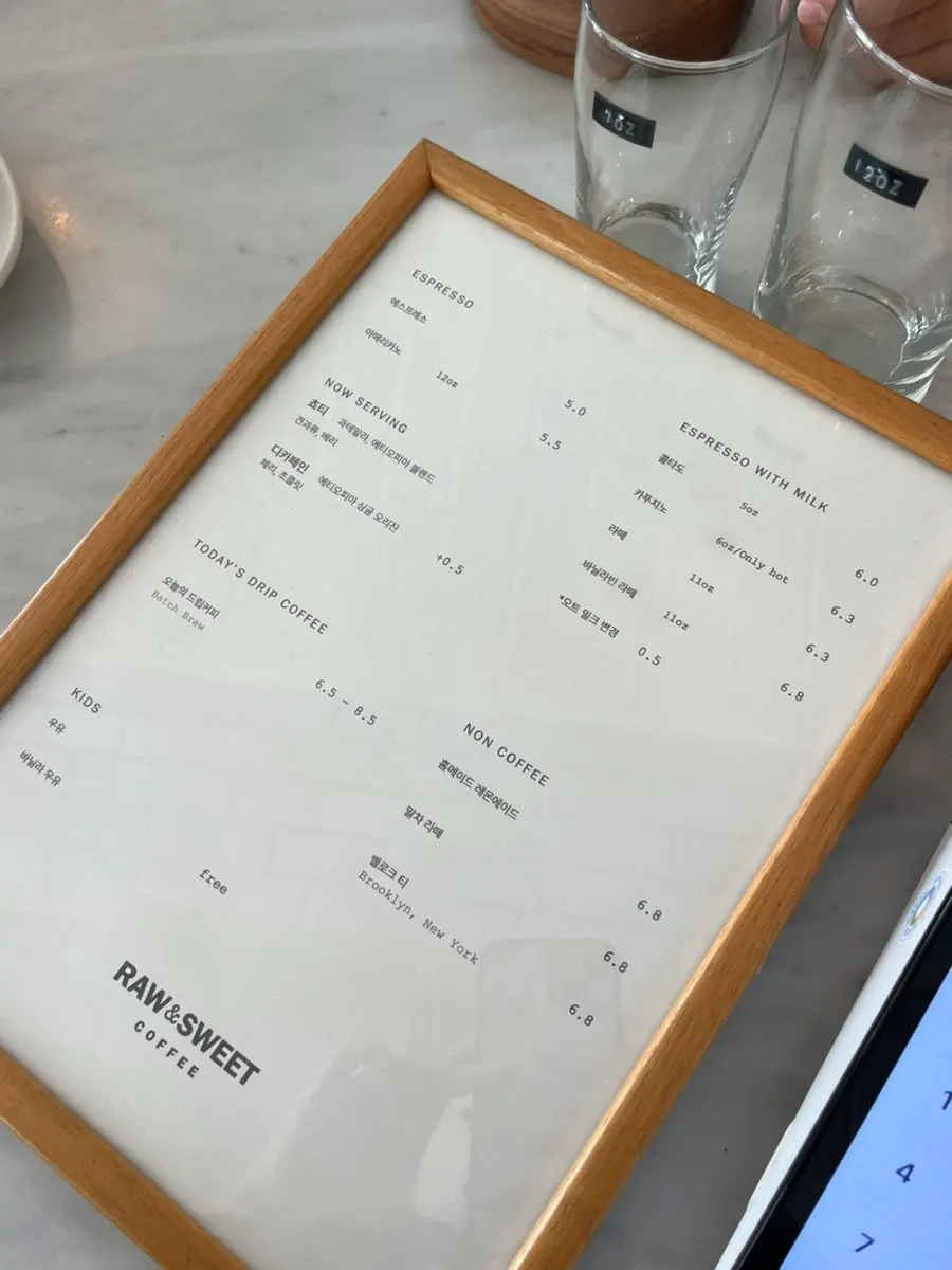 Drink menu board listing espresso and drip coffee