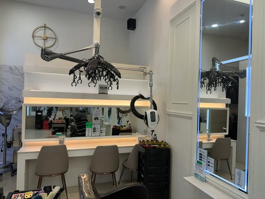Salon interior with yellow lighting and white-toned decor