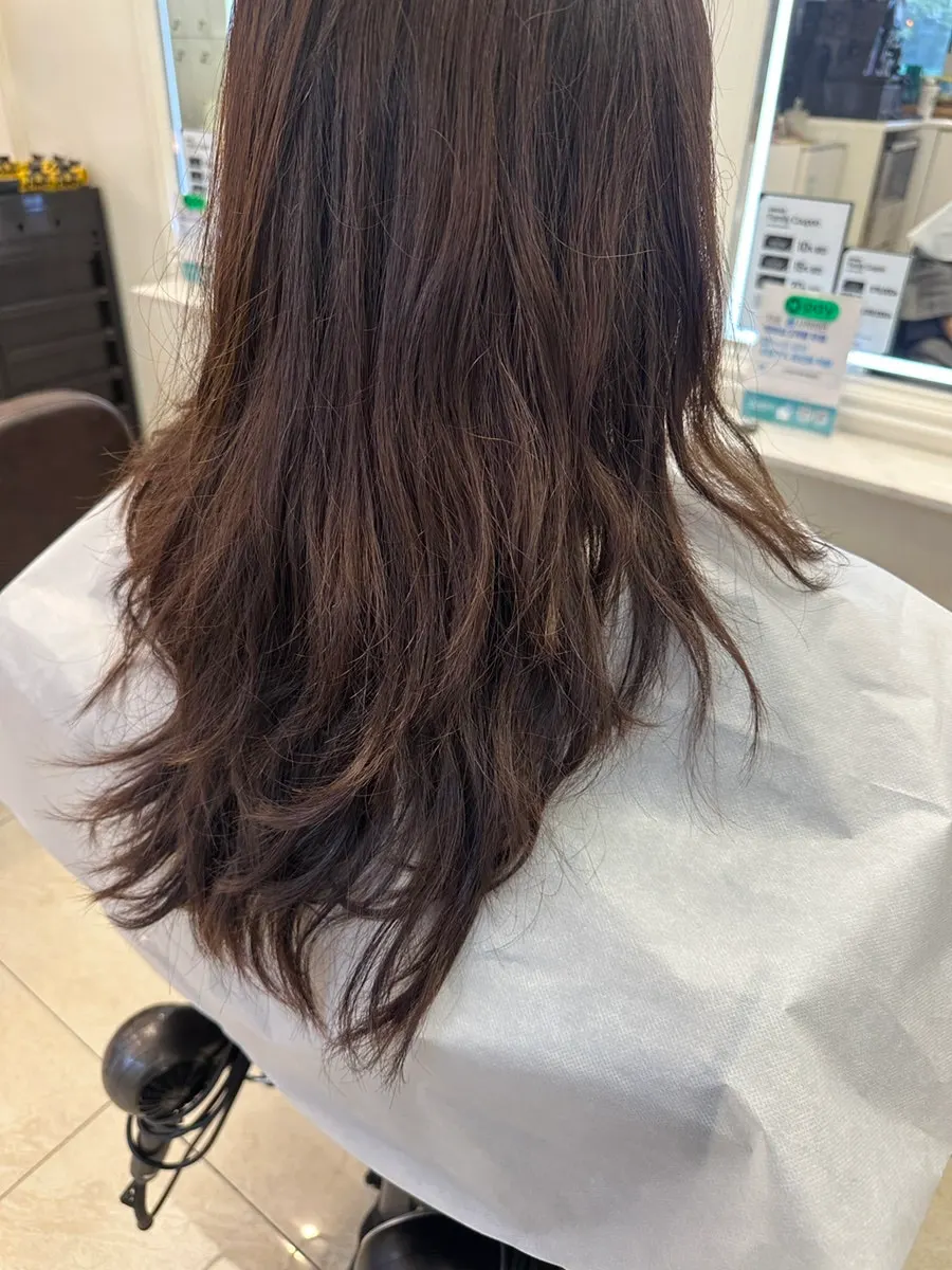 Before shot of damaged hair with flattened curls after a build perm