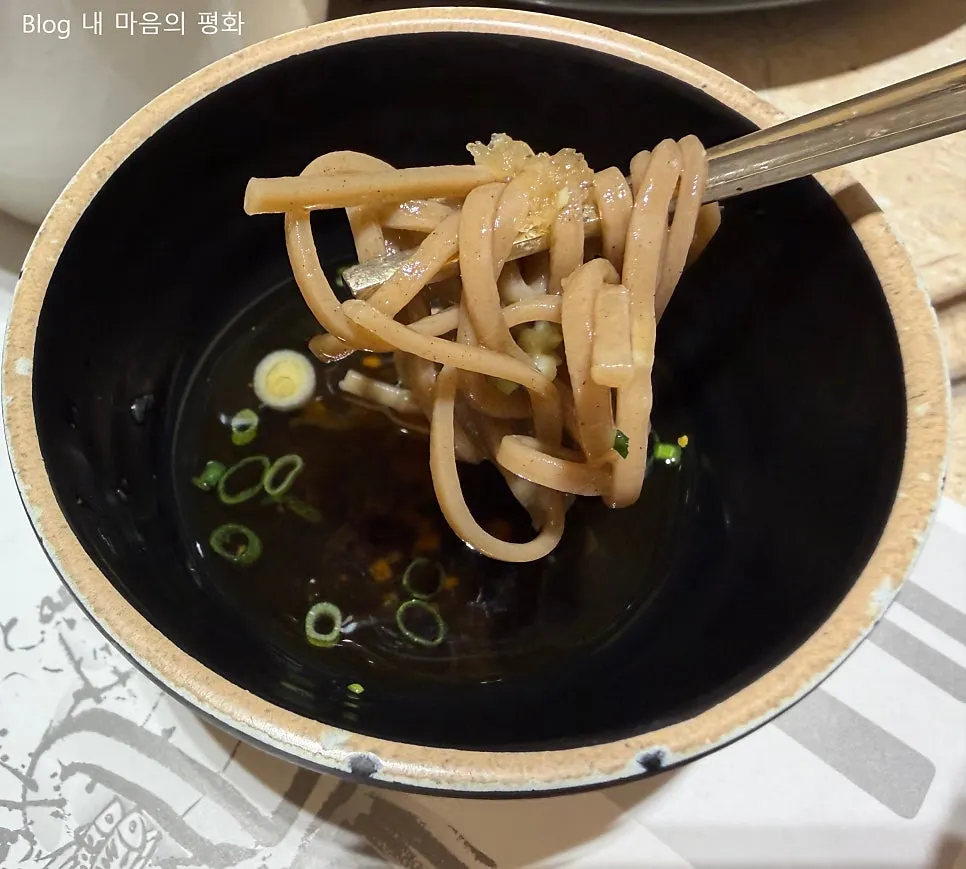 Buckwheat noodles, kimchi pancake, and salad side dishes