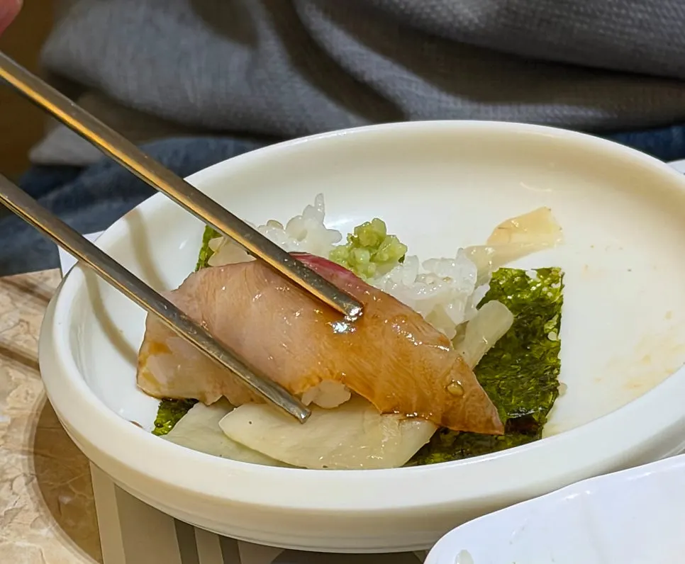 Sashimi wrapped in seaweed with white kimchi and wasabi
