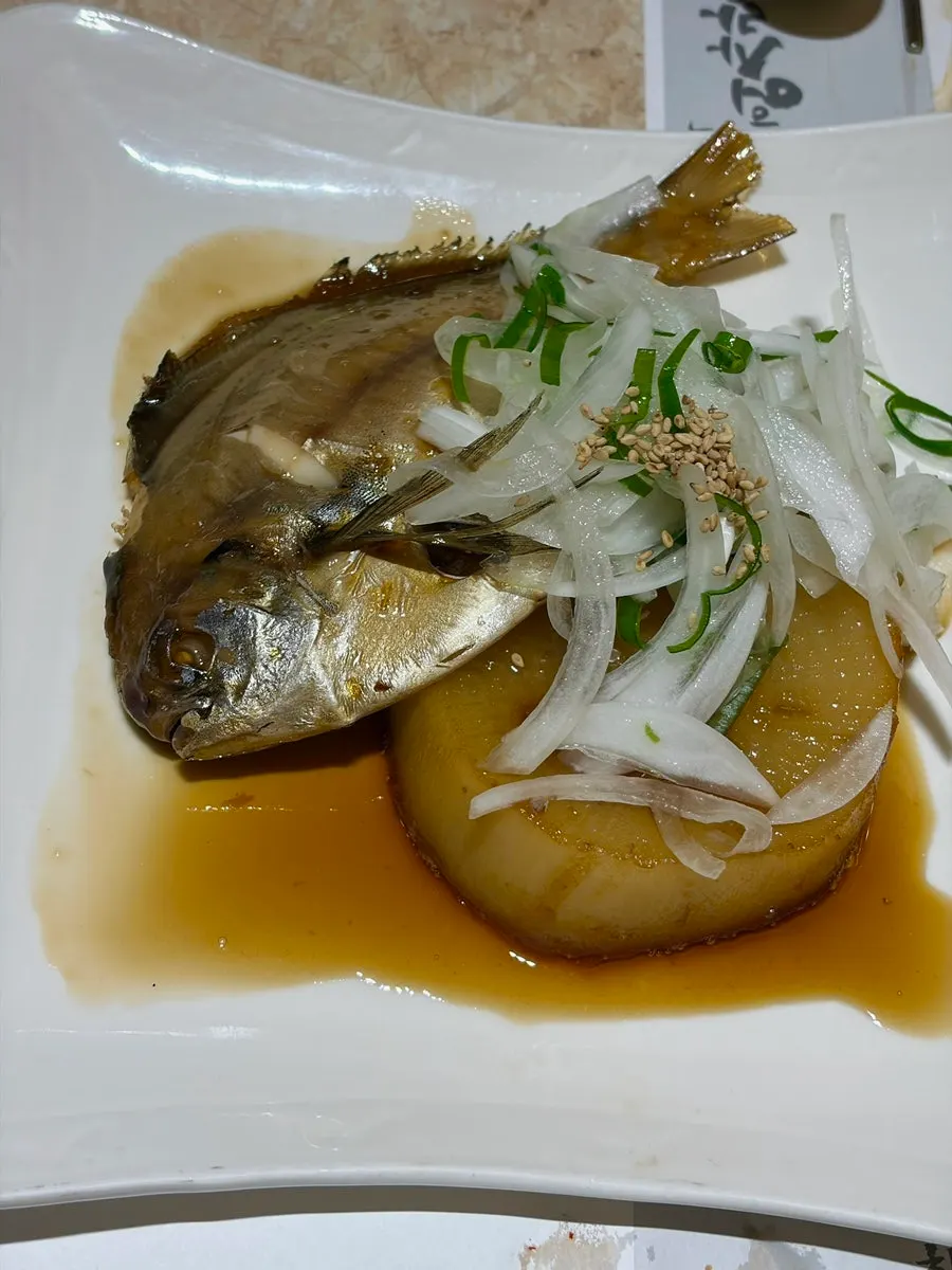 A bong-sushi hand roll topped with an extra piece of mackerel sashimi
