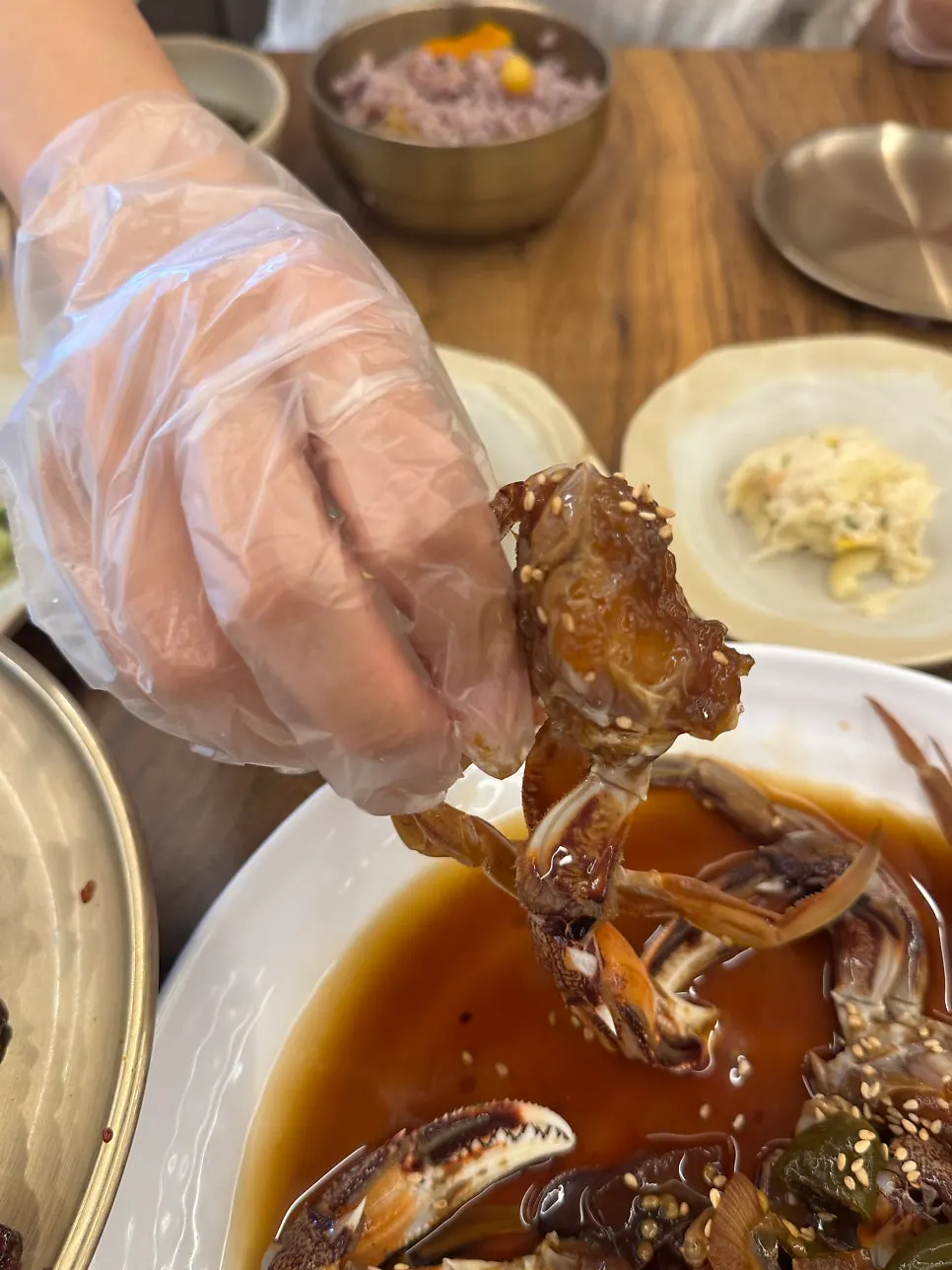 Soy-marinated crab and side dishes served as a full meal