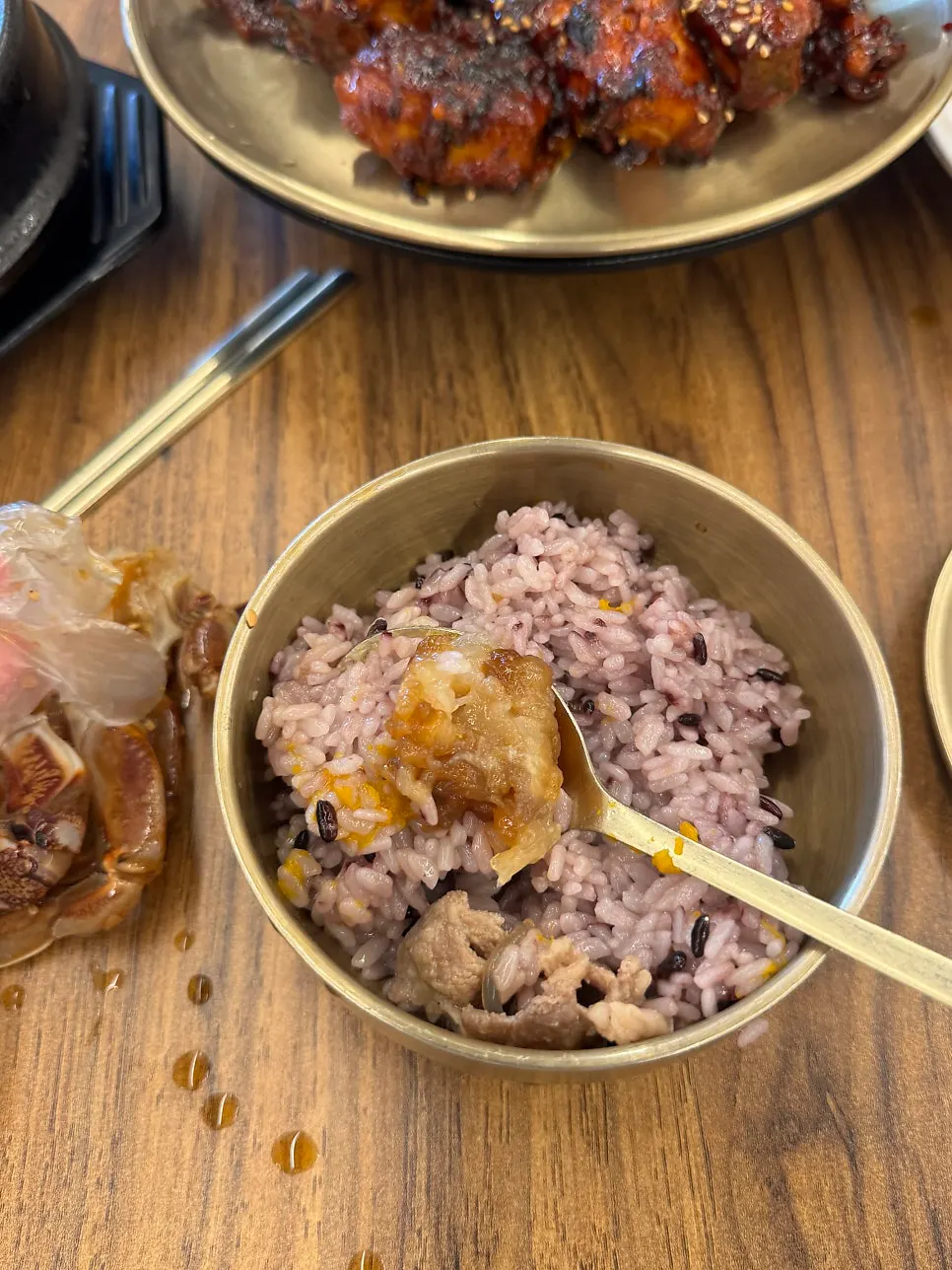 Soy-marinated crab and side dishes served as a full meal