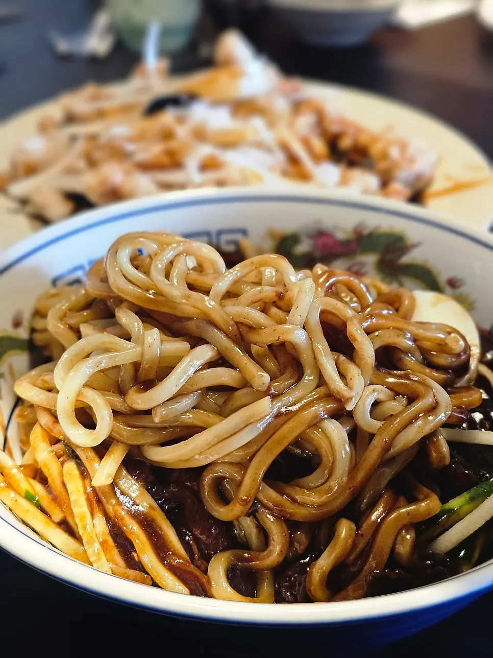 A bowl of jajangmyeon on the table spread