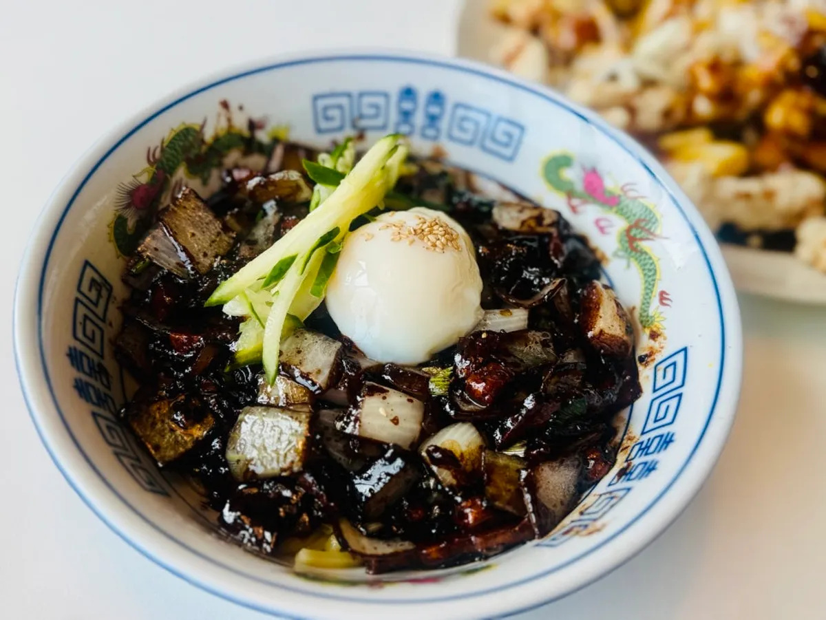 A bowl of jajangmyeon topped with a poached egg