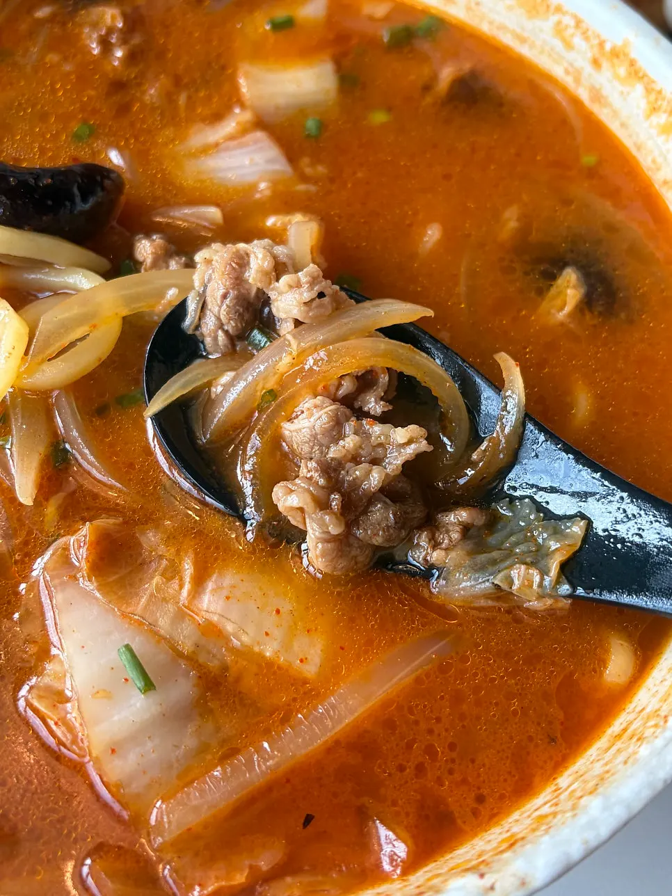 Soft noodles lifted out of the jjamppong