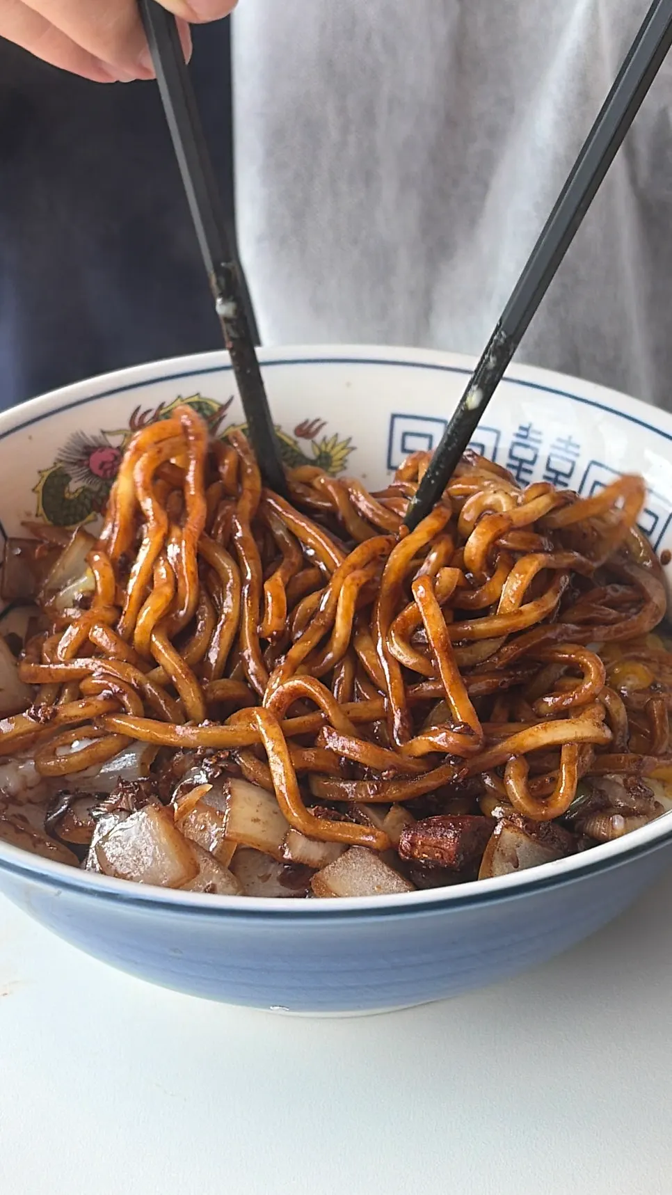 Jajangmyeon topped with a poached egg and shredded cucumber