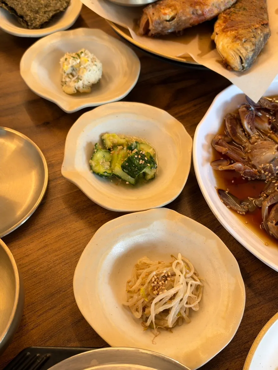 Side dishes at Deodo Gejang including seasoned cucumber and mung bean sprouts