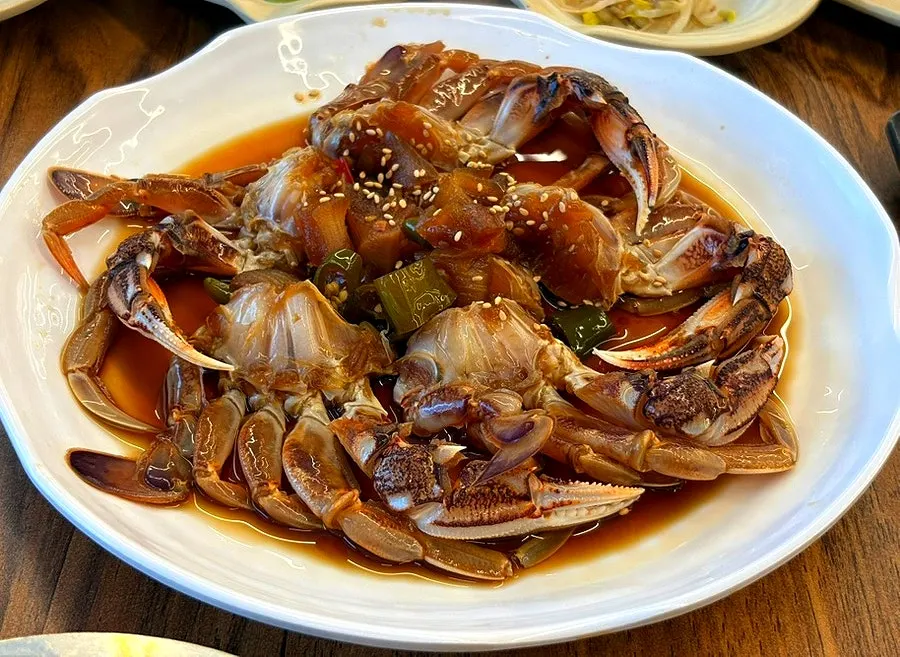 A large plate piled with soy-marinated yellow crab