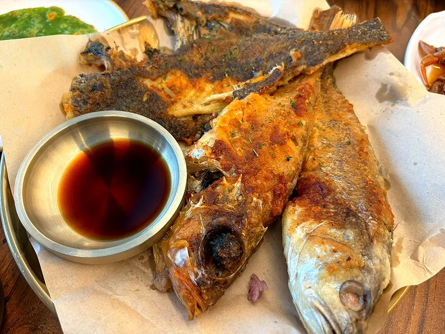 Grilled fish with the flesh picked apart