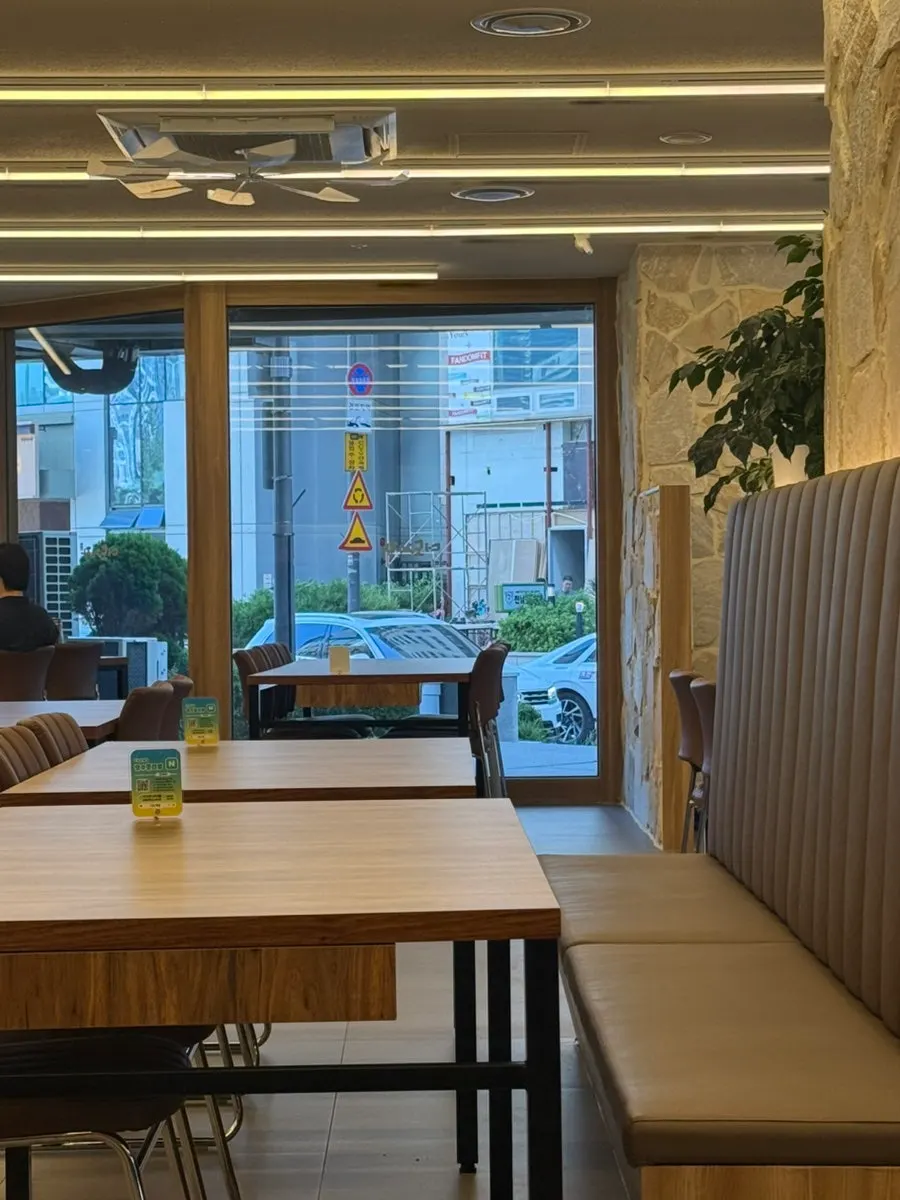 Table seating with wood-toned interior at Deodo Gejang