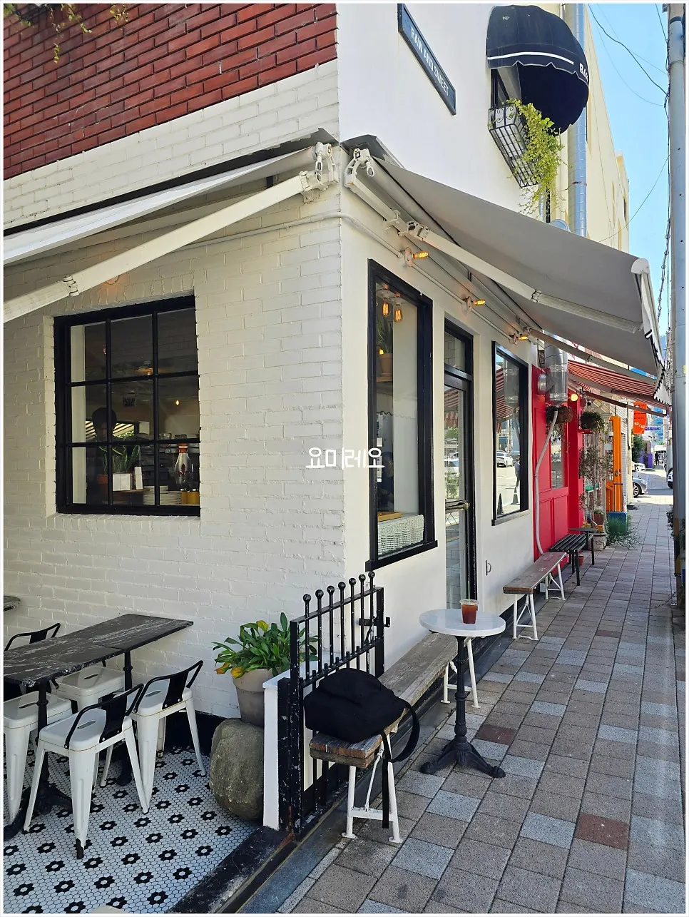 Bakery window exterior with hanging plants