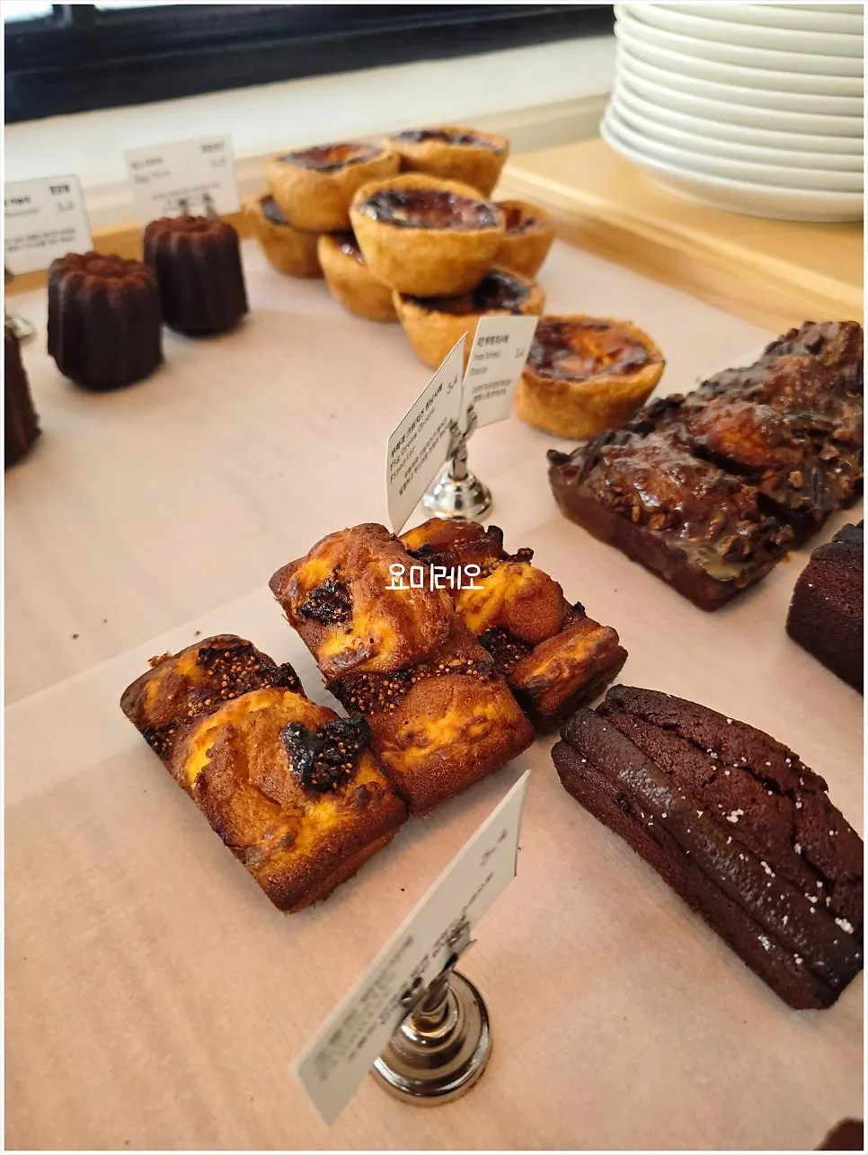 Bakery display with lemon madeleines and canelés