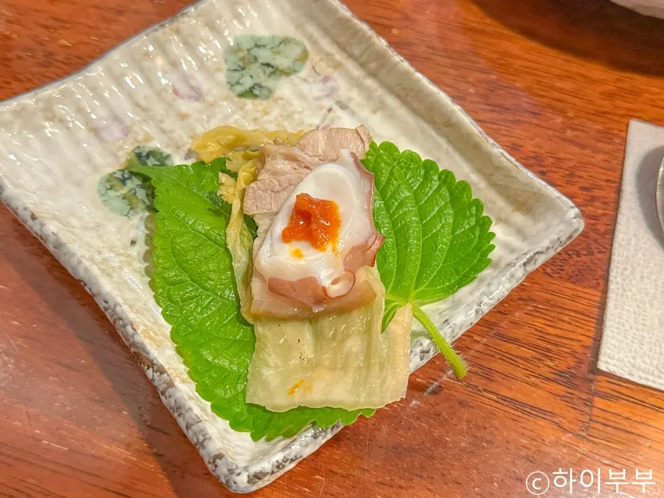 Octopus and bossam wrapped in a perilla leaf
