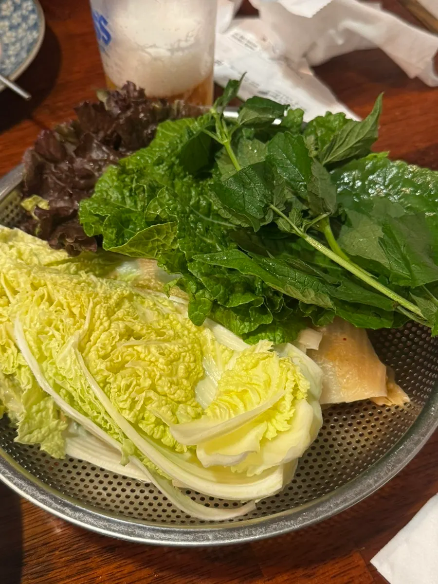 A glass of draft beer with side dishes