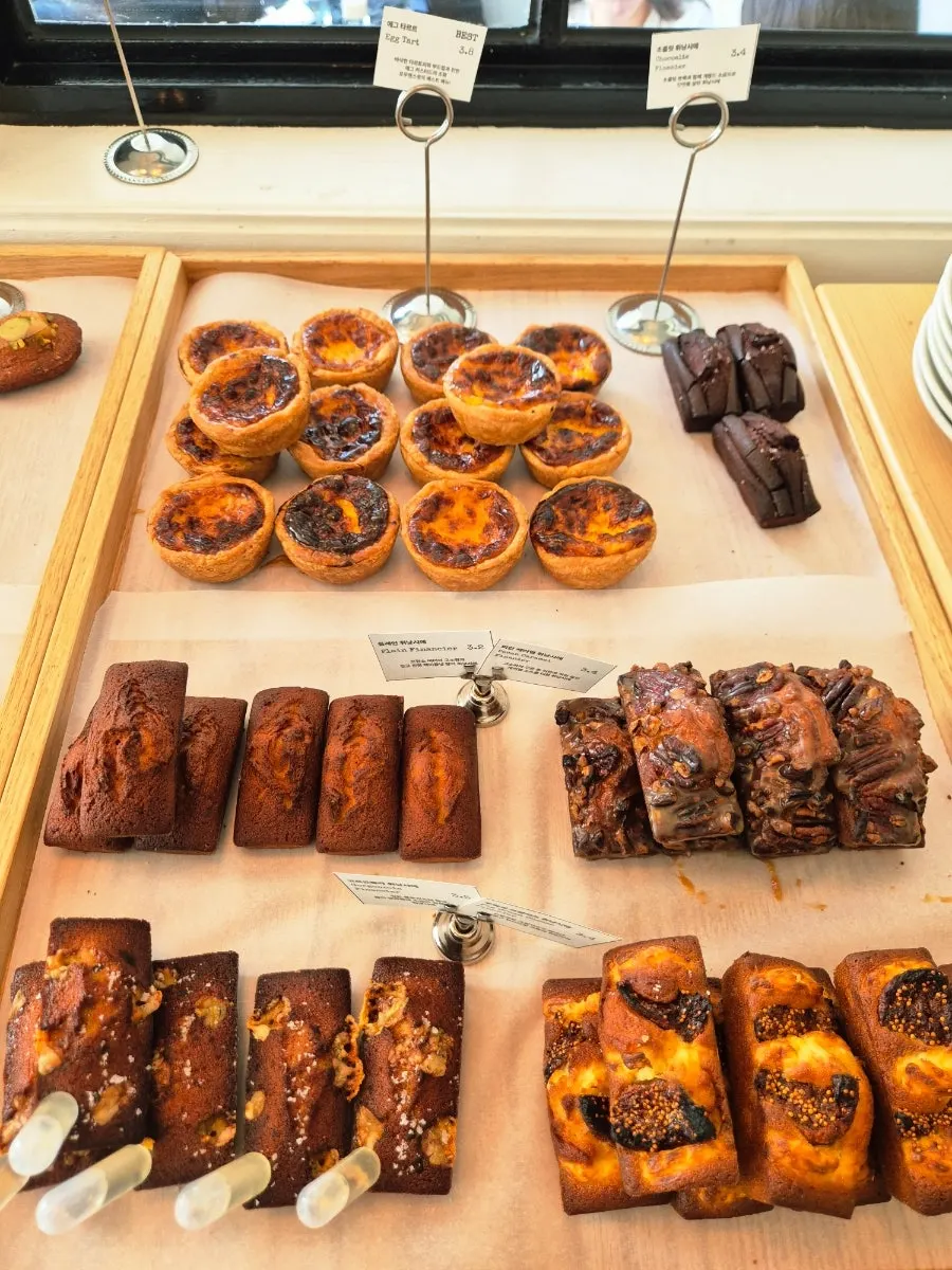 Rows of financiers and canelés in the display case