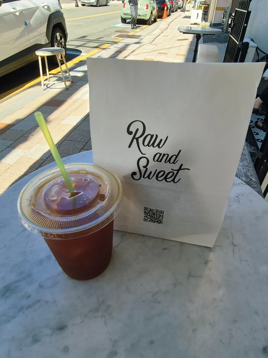 Iced americano and takeout bag on the table