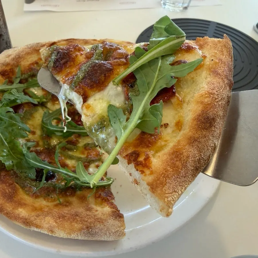 Margherita pizza with a basil pesto base