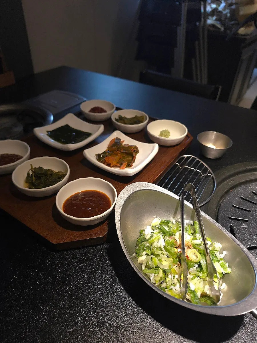 Seokok Galbi table setting with sauces and side dishes