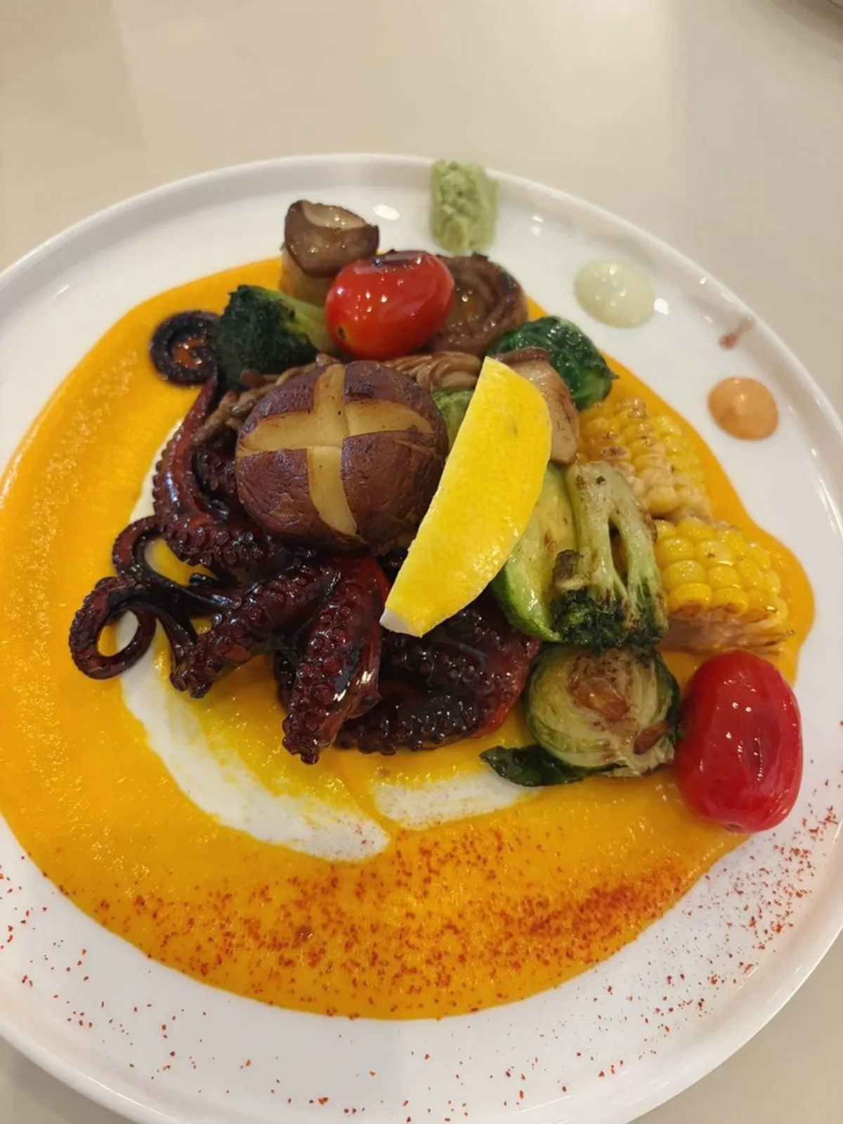 Stone octopus steak served with three sauces